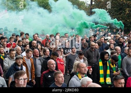 Protest march at Manchester United against Glazer owners. Large crowd. `Green smoke. Football match against Liverpool United.